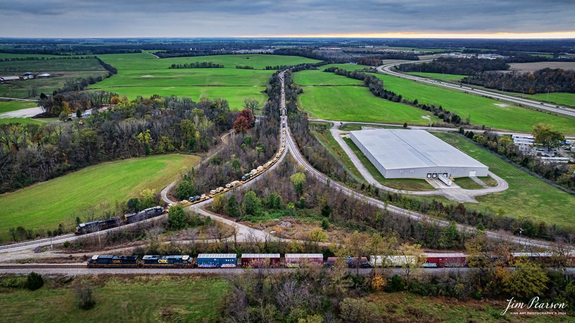 CSX S710 sits on the Fort Campbell Wye where it was picking up a loaded military train from Fort Campbell, Kentucky, as they wait for southbound CSX M501 to pass them on the CSX Henderson Subdivision at Hopkinsville, Kentucky on November15th, 2024.
Once M501 clears the block S710 will pull out onto the main so they can pick up the last half of their train, before proceeding on to Nashville, Tennessee.

Tech Info: DJI Mavic 3 Classic Drone, RAW, 24mm, f/5, 1/320, ISO 800.

#militarytrain #besttrainphotograph #bestphoto #photographyoftrains #bestsoldpicture #JimPearsonPhotography