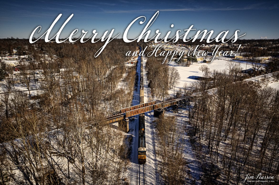 CSX G419, a loaded grain train, passes under the Paducah and Louisville Railway, on a 11-degree snowy winters day, as it heads south at the location known as Monarch on the Henderson Subdivision at Madisonville, Kentucky on January 7th, 2022.

Tech Info: DJI Mavic Air 2S Drone, RAW, 22mm, f/2.8, 1/3000, ISO 130.

#trainphotography #railroadphotography #trains #railways #jimpearsonphotography #trainphotographer #railroadphotographer