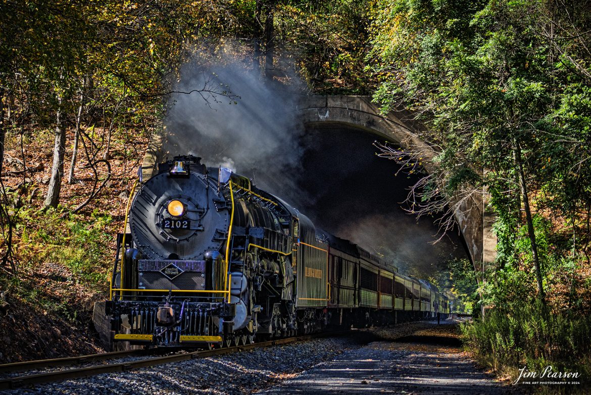 Reading & Northern's 2102 steam locomotive leads a passenger train towards Port Clinton, Pennsylvania, passing through Nesquehoning Tunnel on October 5th, 2024.

According to their website: The Reading Company T-1 class #2102 was built in the Reading’s own locomotive shops in 1945. With drivers of 70” diameter, it weighs 404 tons, and its tender holds up to 26 tons of coal, and up to 19,000 gallons of water. After the Reading Steam era was over, the Reading Company used 2102 for the Reading Rambles on several different excursions. The 2102 has had many different owners since it was retired by the Reading Railroad. It is one of only four to survive. The other remaining locomotives are the 2100, 2101, and 2124.

The Blue Mountain and Reading Railroad purchased the 2102 in 1987, and it ran on the Temple to South Hamburg line into the early 1990’s. Once the Blue Mountain and Reading Railroad became the Reading Blue Mountain & Northern, the 2102 ran over Reading & Northern’s rails for a short time before it was removed from service in the early 1990’s. 

In 2022, steam locomotive 2102 reentered service on the Reading & Northern. The locomotive has been used actively to pull both passenger excursions and revenue freight trains.

Tech Info: Nikon D810, RAW, Nikon 70-300 @ 70mm, f/4.5, 1400, ISO 400.

#steamtrains #besttrainphotograph #JimPearsonPhotography #RBNRR