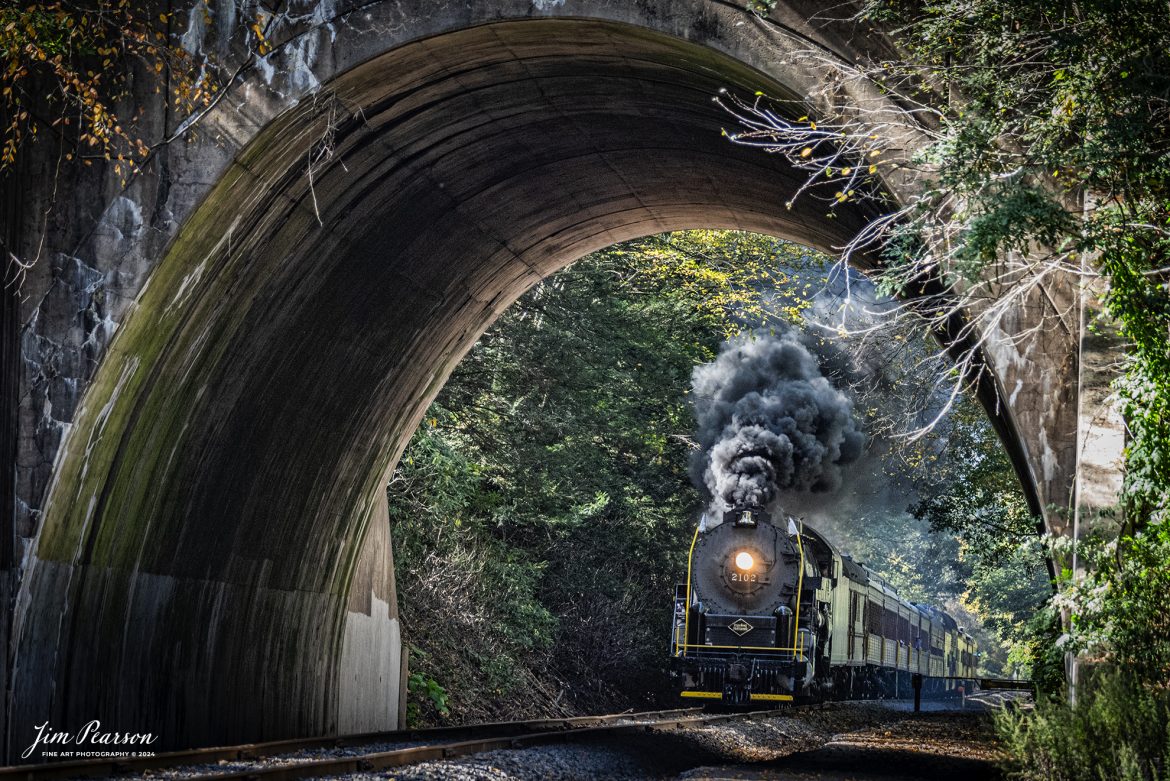 Reading & Northern's 2102 steam locomotive leads a passenger train towards Port Clinton, Pennsylvania, as they approach Nesquehoning Tunnel on October 5th, 2024.

According to their website: The Reading Company T-1 class #2102 was built in the Reading’s own locomotive shops in 1945. With drivers of 70” diameter, it weighs 404 tons, and its tender holds up to 26 tons of coal, and up to 19,000 gallons of water. After the Reading Steam era was over, the Reading Company used 2102 for the Reading Rambles on several different excursions. The 2102 has had many different owners since it was retired by the Reading Railroad. It is one of only four to survive. The other remaining locomotives are the 2100, 2101, and 2124.

The Blue Mountain and Reading Railroad purchased the 2102 in 1987, and it ran on the Temple to South Hamburg line into the early 1990’s. Once the Blue Mountain and Reading Railroad became the Reading Blue Mountain & Northern, the 2102 ran over Reading & Northern’s rails for a short time before it was removed from service in the early 1990’s. 

In 2022, steam locomotive 2102 reentered service on the Reading & Northern. The locomotive has been used actively to pull both passenger excursions and revenue freight trains.

Tech Info: Nikon D810, RAW, Nikon 70-300 @ 170mm, f/5.3, 1/400, ISO 1800.

#steamtrains #besttrainphotograph #JimPearsonPhotography #RBNRR