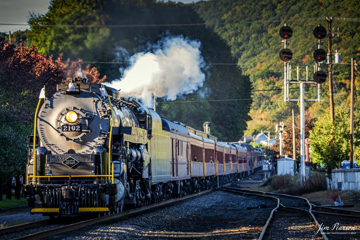 Reading Blue Mountain & Northern Railroad steam locomotive 2102 steams through one of many communities as it heads back to Port Clinton, Pennsylvania on October 5th, 2024 after taking a trainload of passengers to Jim Thorpe, PA on the first day of the year of Fall Foliage Excursions.

According to their website: The Reading Company T-1 class #2102 was built in the Reading’s own locomotive shops in 1945. With drivers of 70” diameter, it weighs 404 tons, and its tender holds up to 26 tons of coal, and up to 19,000 gallons of water. After the Reading Steam era was over, the Reading Company used 2102 for the Reading Rambles on several different excursions. The 2102 has had many different owners since it was retired by the Reading Railroad. It is one of only four to survive. The other remaining locomotives are the 2100, 2101, and 2124.

The Blue Mountain and Reading Railroad purchased the 2102 in 1987, and it ran on the Temple to South Hamburg line into the early 1990’s. Once the Blue Mountain and Reading Railroad became the Reading Blue Mountain & Northern, the 2102 ran over Reading & Northern’s rails for a short time before it was removed from service in the early 1990’s. 

In 2022, steam locomotive 2102 reentered service on the Reading & Northern. The locomotive has been used actively to pull both passenger excursions and revenue freight trains.

Tech Info: Nikon D810, RAW, Nikon 70-300 @ 140mm, 1/320, f/5, ISO 450.

#railroad #railroads #train, #trains #railway #railway #steamtrains #railtransport #railroadengines #picturesoftrains #picturesofrailways #besttrainphotograph #bestphoto #photographyoftrains #bestsoldpicture #JimPearsonPhotography #RBNRR