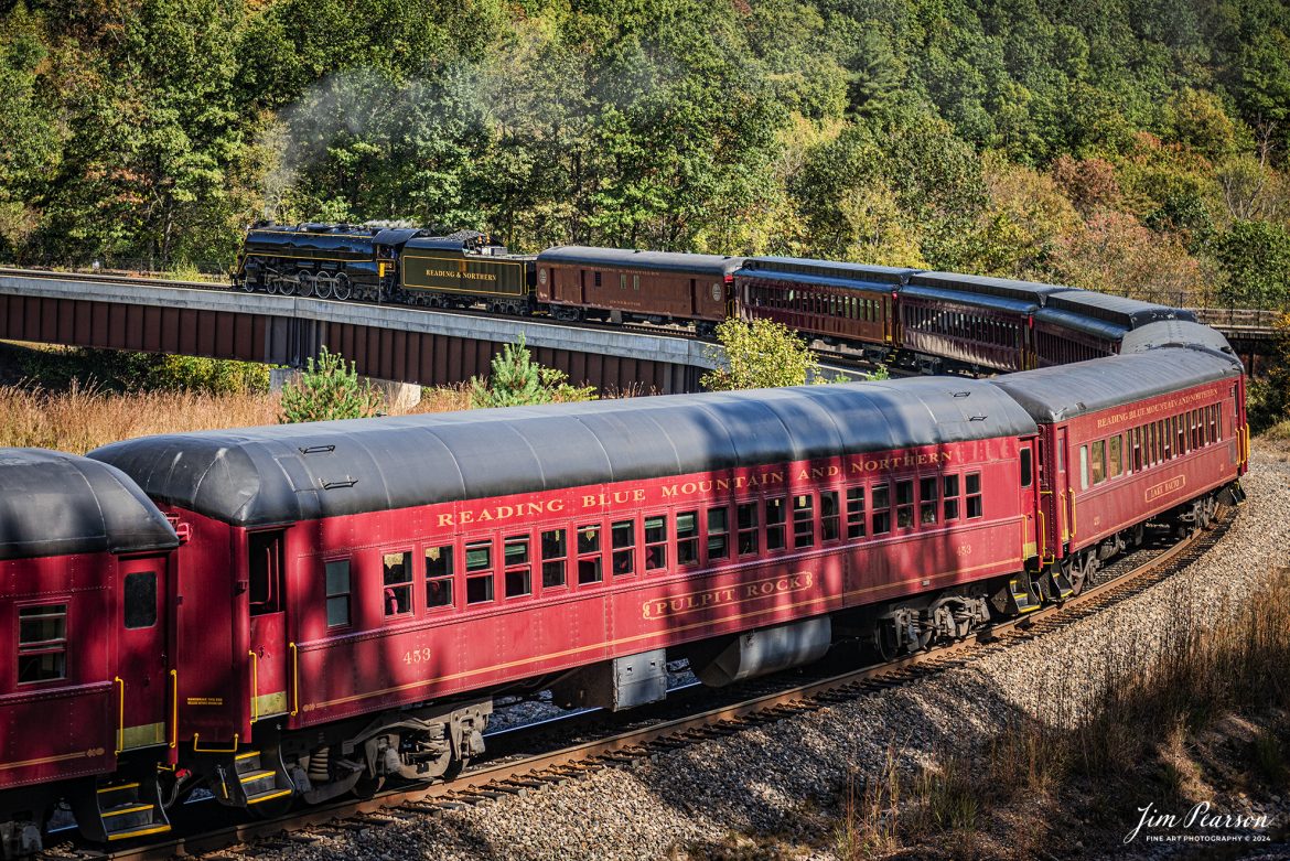 Reading & Northern's 2102 steam locomotive leads a passenger train as they turn their train on the wye just outside of Jim Thorpe, Pennsylvania on October 5th, 2024.

According to their website: The Reading Company T-1 class #2102 was built in the Reading’s own locomotive shops in 1945. With drivers of 70” diameter, it weighs 404 tons, and its tender holds up to 26 tons of coal, and up to 19,000 gallons of water. After the Reading Steam era was over, the Reading Company used 2102 for the Reading Rambles on several different excursions. The 2102 has had many different owners since it was retired by the Reading Railroad. It is one of only four to survive. The other remaining locomotives are the 2100, 2101, and 2124.

The Blue Mountain and Reading Railroad purchased the 2102 in 1987, and it ran on the Temple to South Hamburg line into the early 1990’s. Once the Blue Mountain and Reading Railroad became the Reading Blue Mountain & Northern, the 2102 ran over Reading & Northern’s rails for a short time before it was removed from service in the early 1990’s. 

In 2022, steam locomotive 2102 reentered service on the Reading & Northern. The locomotive has been used actively to pull both passenger excursions and revenue freight trains.

Tech Info: Nikon D810, RAW, Nikon 24-70 @ 60mm, f/2.8, 1/2000, ISO 160.

#steamtrains #besttrainphotograph #JimPearsonPhotography #RBNRR