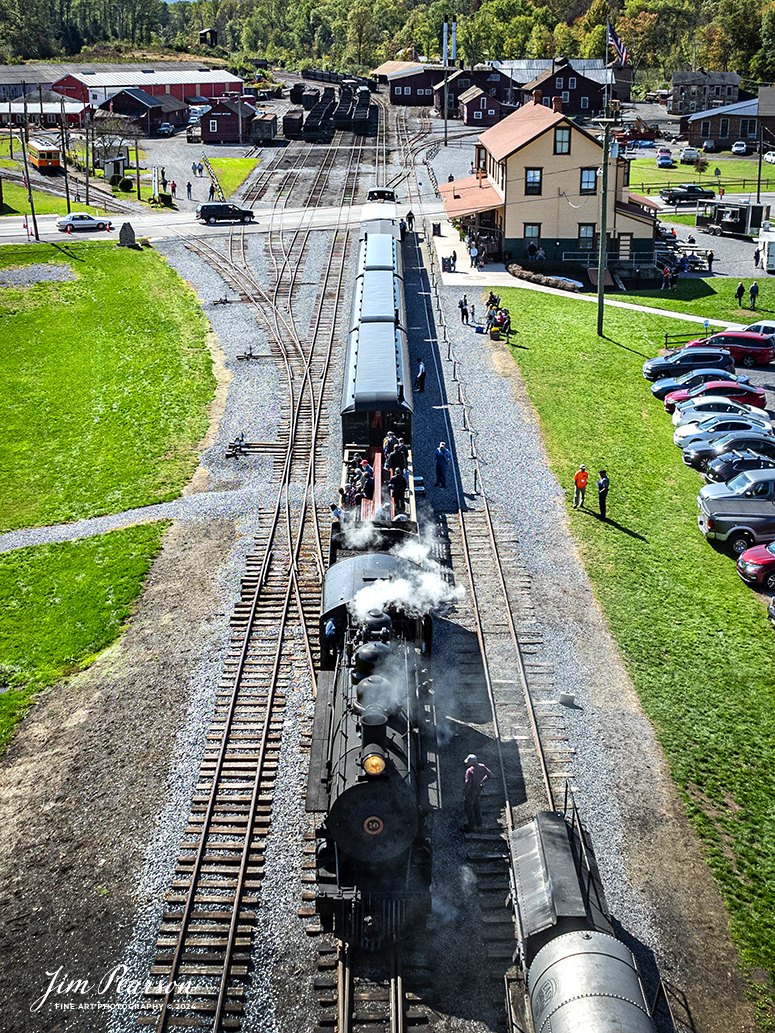 East Broad Top (EBT) steam locomotive 16 leads a passenger train as they wait to depart from the depot at Rockhill Furnace, Pennsylvania, on October 6th, 2024.

According to the East Broad Top Website: Locomotive #16 was built in 1916 by the Baldwin Locomotive Works.

Entering the age of modern steam in 1916, the EBT received its first of three large Mikados. Unlike the previous three smaller locomotives, #16 came with superheaters, piston valves, and Southern valve gear. One story mentions #16 pulled 60 empty hoppers from Mt. Union to Rockhill in one train, literally clearing out the yard. #16 underwent an overhaul in 1955 and made only a handful of trips in early 1956 before the railroad shut down an overhaul when the EBT shut down. On February 1, 2023, the locomotive returned to service.

Tech Info: DJI Mavic 3 Classic Drone, RAW, 24mm, f/2.8, 1/2500, ISO 180.

#steamtrains #JimPearsonPhotography #trainsfromtheair #EastBroadTop