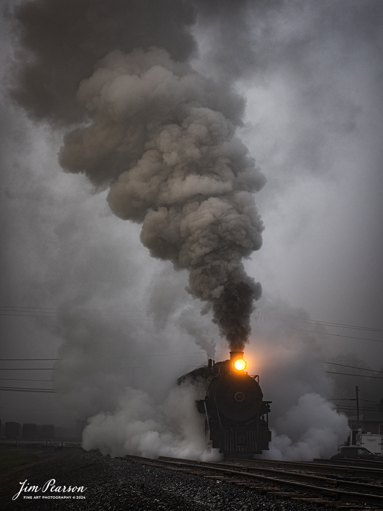 East Broad Top (EBT) steam locomotive #16 pulls a mixed freight through the early morning fog as they head out of the yard at Rockhill Furnace, Pennsylvania on October 6th, 2024, during the museum’s Friends of the East Broad top event.

According to the East Broad Top Website: Locomotive #16 was built in 1916 by the Baldwin Locomotive Works.

Entering the age of modern steam in 1916, the EBT received its first of three large Mikados. Unlike the previous three smaller locomotives, #16 came with superheaters, piston valves, and Southern valve gear. One story mentions #16 pulled 60 empty hoppers from Mt. Union to Rockhill in one train, literally clearing out the yard. #16 underwent an overhaul in 1955 and made only a handful of trips in early 1956 before the railroad shut down. On February 1, 2023, the locomotive returned to service.

Tech Info: Nikon D810, RAW, Nikon 24-70 @70mm, f/2.8, 1/400, ISO 72.

steam locomotive, train, railways, vintage, smoke, green hillside, sunlight, iron bridge, transportation, travel, photography of trains, train photography, Jim Pearson Photography, trending photo, East Broad Top Railroad, steam train