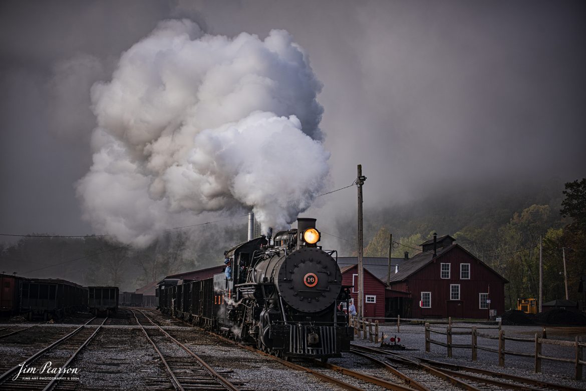 East Broad Top (EBT) steam locomotive #16 pulls a mixed freight through the early morning fog as they head out of the yard at Rockhill Furnace, Pennsylvania on October 6th, 2024, during the museum’s Friends of the East Broad top event.

According to the East Broad Top Website: Locomotive #16 was built in 1916 by the Baldwin Locomotive Works.

Entering the age of modern steam in 1916, the EBT received its first of three large Mikados. Unlike the previous three smaller locomotives, #16 came with superheaters, piston valves, and Southern valve gear. One story mentions #16 pulled 60 empty hoppers from Mt. Union to Rockhill in one train, literally clearing out the yard. #16 underwent an overhaul in 1955 and made only a handful of trips in early 1956 before the railroad shut down. On February 1, 2023, the locomotive returned to service.

Tech Info: Nikon D810, RAW, Nikon 70-300 @70mm, f/4.5, 1/400, ISO 64.

steam locomotive, train, railways, vintage, smoke, green hillside, sunlight, iron bridge, transportation, travel, photography of trains, train photography, Jim Pearson Photography, trending photo, East Broad Top Railroad, steam train