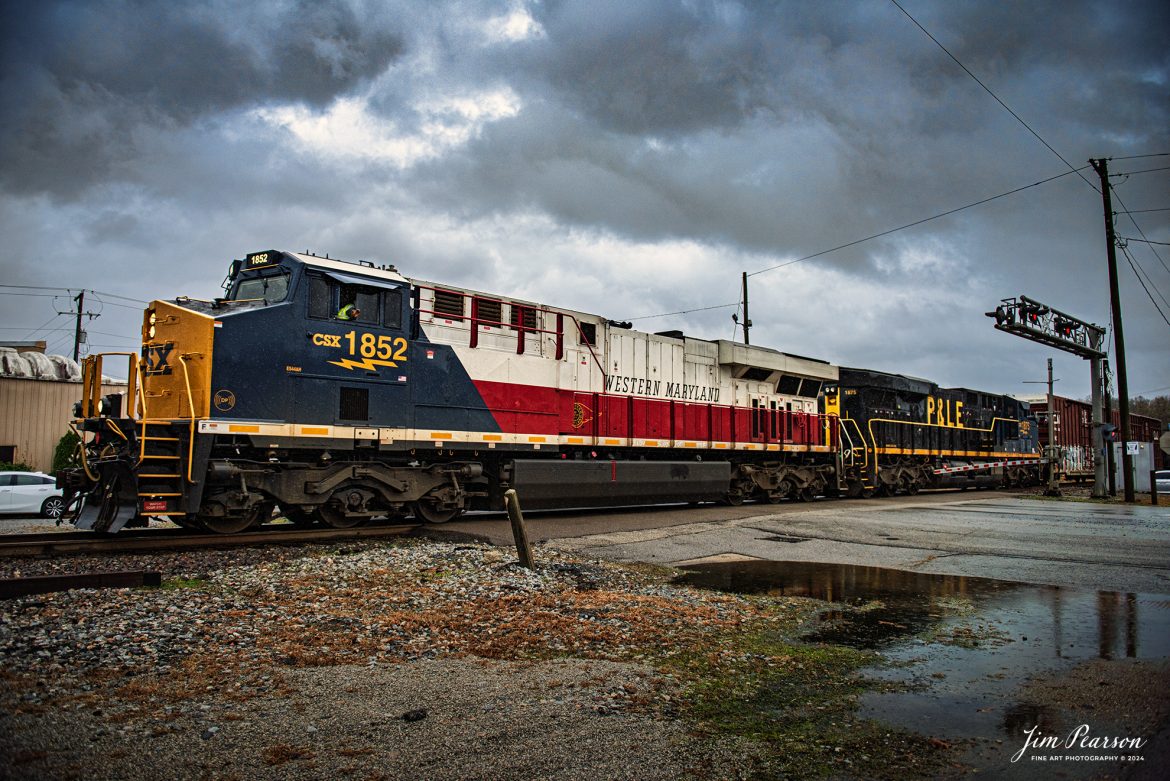 This is my first catch where there were two CSX Heritage Units leading a train! I got word about this move on CSX M648 the day before and when it finally arrived where I setup to catch it the first time at Mortons Gap, Ky the wind and rain was bad, but I did get a short video clip here is in my December 21st, 2024, Saturday Edited Video.

In this shot the the conductor gives a friendly wave from the cab of CSX Western Maryland Heritage unit as it and P&LE Heritage units lead CSX M648 they head north through downtown Sebree, Kentucky, on the CSX Henderson Subdivision on December 16th 2024.

According to the CSX Website: The Western Maryland Railroad operated between 1852 and 1983 in Maryland, West Virginia, and Pennsylvania. It was a small railroad that primarily transported coal and freight.

“In 1983 the Western Maryland fully merged with the B&O (Baltimore and Ohio Railroad), which merged with the C&O (Chesapeake and Ohio Railroad) in 1987. They eventually merged with the Seaboard System to form CSX.” explained Tim Music, a CSX carman painter who assisted with the project.

The Pittsburgh & Lake Erie Railroad was established in 1875 with a primary mission of transporting essential industrial materials such as coal, coke, iron ore, limestone, and steel among the bustling industrial hubs of the region.

“It’s mainline connected Pittsburgh, Pennsylvania with Youngstown, Ohio and Connellsville, Pennsylvania. It did not actually reach Lake Erie until 1976,” explained Tim Music, a carman painter at the CSX Waycross Locomotive Shop where the unit was produced.

Despite its relatively modest route mileage, the P&LE Railroad earned the nickname “Little Giant” due to the enormous volume of heavy tonnage it moved. This impressive capability drew significant attention and by 1887, the P&LE became a subsidiary of the dominant New York Central Railroad. Under this new ownership, the P&LE enjoyed substantial improvements to its tracks and added capacity for passenger services, further enhancing its regional significance.

Tech Info: DJI Mavic 3 Classic Drone, RAW, 24mm, f/2.8, 1/1250, ISO 360.

#railroad #railroads #train, #trains #railway #railway #railtransport #railroadengines #picturesoftrains #picturesofrailways #besttrainphotograph #bestphoto #photographyoftrains #bestsoldpicture #JimPearsonPhotography #trainsfromadrone #csxheritagelocomotives