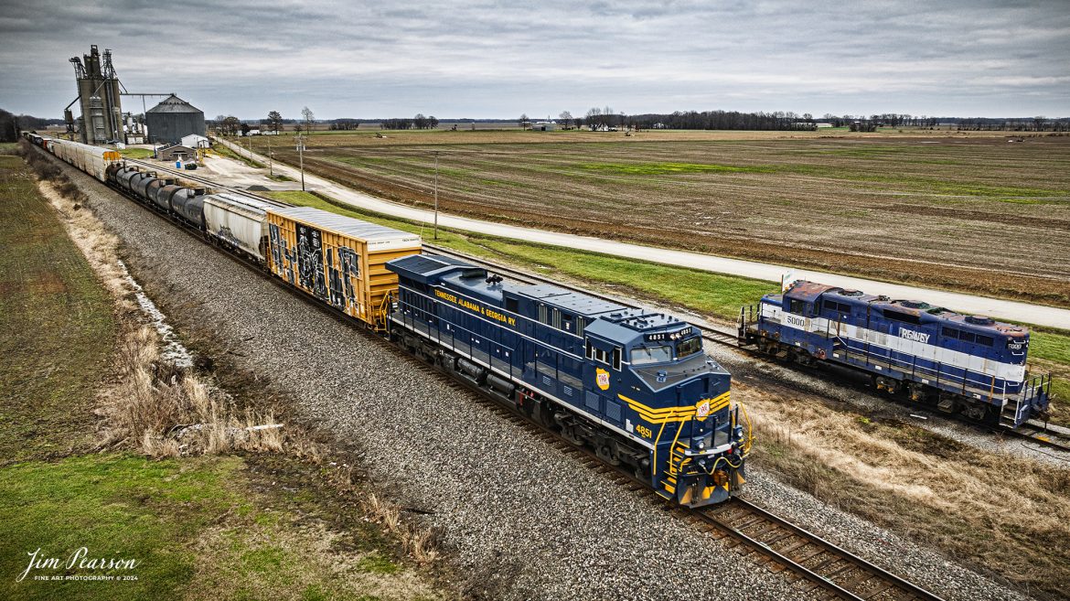 I spent New Year’s Day with fellow railfan Ryan Scott and we spent it chasing Norfolk Southern’s newest Heritage Unit, Tennessee, Alabama & Georgia Railway locomotive 4851 as it ran as the DPU on NS 167 On January 1st, 2025.

The first location was at the Viterra Grain elevator that is located at Browns, Illinois, just east of Albion, IL, as the engine passed their GP9 5000 there. This locomotive was built for the Milwaukee Road in May 1959, as MILW 311. From the Milwaukee, this engine worked for Indiana Railroad (IRRC 311), Nucor Steel (NUCX 311), and ConAgra (CAGX 5000) and now Viterra, although I’m not sure if it is still in use today.

Norfolk Southern recently unveiled their newest addition to their Heritage Fleet: the Tennessee, Alabama & Georgia Railway locomotive!

“Once a vital link between Chattanooga and Gadsden, the TAG Railway played a key role in moving coal, steel, and more. Its legacy is now proudly reflected in our fleet.”

Tech Info: DJI Mavic 3 Classic Drone, RAW, 24mm, f/2.8, 1/400, ISO 140.

#railroad #railroads #train, #trains #railway #railway #railtransport #railroadengines #picturesoftrains #picturesofrailways #besttrainphotograph #bestphoto #photographyoftrains #bestsoldpicture #JimPearsonPhotography #trainsfromadrone #nsheritagelocomotives #NSTAGlocomotive