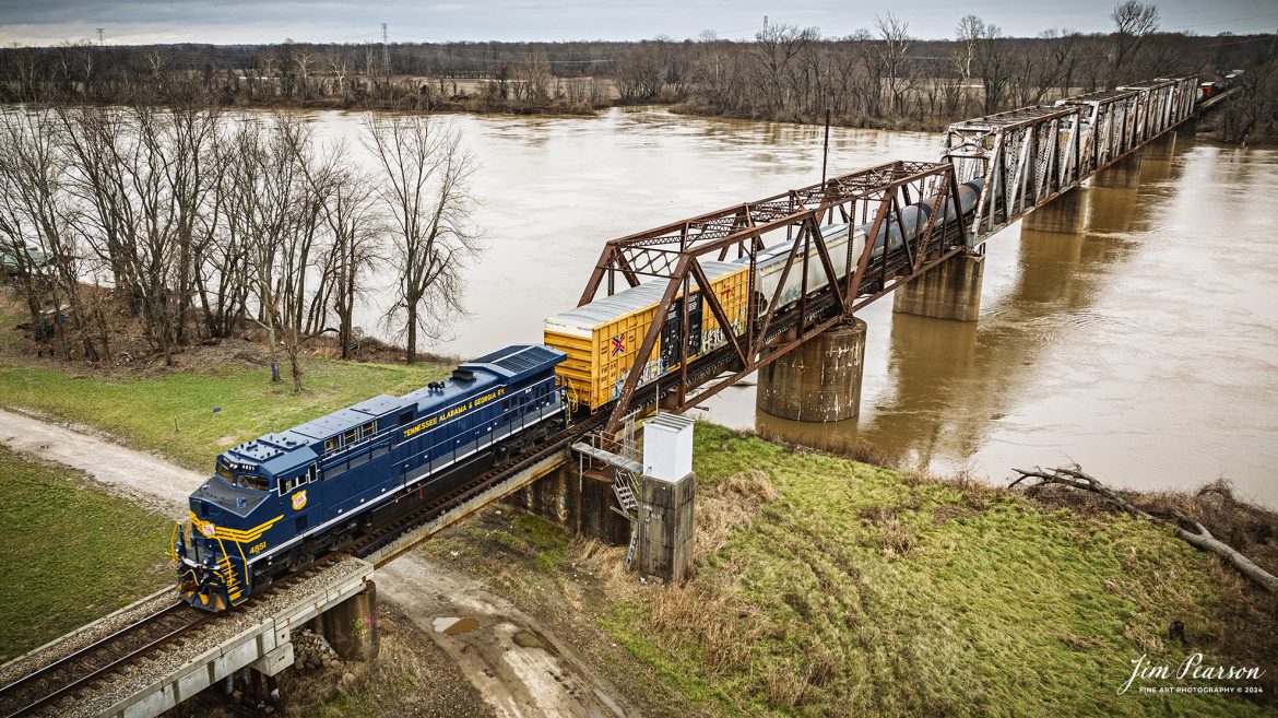 I spent New Year’s Day with fellow railfan Ryan Scott and we spent it chasing Norfolk Southern’s newest Heritage Unit, Tennessee, Alabama & Georgia Railway locomotive 4851 as it ran as the DPU on NS 167 On January 1st, 2025. Here the TAG locomotive prepares to pass over the Wabash river at Mt. Carmel, IL on their move east.

Norfolk Southern recently unveiled their newest addition to their Heritage Fleet: the Tennessee, Alabama & Georgia Railway locomotive!

“Once a vital link between Chattanooga and Gadsden, the TAG Railway played a key role in moving coal, steel, and more. Its legacy is now proudly reflected in our fleet.”

Tech Info: DJI Mavic 3 Classic Drone, RAW, 24mm, f/2.8, 1/400, ISO 120.

#railroad #railroads #train, #trains #railway #railway #railtransport #railroadengines #picturesoftrains #picturesofrailways #besttrainphotograph #bestphoto #photographyoftrains #bestsoldpicture #JimPearsonPhotography #trainsfromadrone #nsheritagelocomotives #NSTAGlocomotive