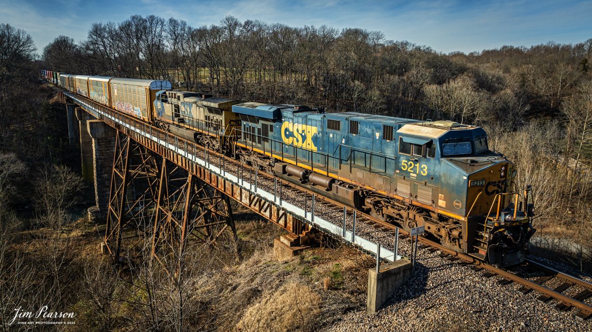 CSXT 5213 leads hot intermodal I025 as they head south over the Sulfur Creek bridge at Springfield, TN, on the CSX Henderson Subdivision on their way to their final destination of Jacksonville, FL from Chicago, IL, on January 9th, 2025. 

This train usually runs with some autoracks that carry Tesla automobiles for the overseas market, so I'm told.

Tech Info: DJI Mavic Classic 3 Drone, RAW, 4.5mm (24mm equivalent lens) f/2.8, 1/2000, ISO 150.

#railroad #railroads #train #trains #bestphoto #railroadengines #picturesoftrains #picturesofrailway #bestphotograph #photographyoftrains #trainphotography #JimPearsonPhotography