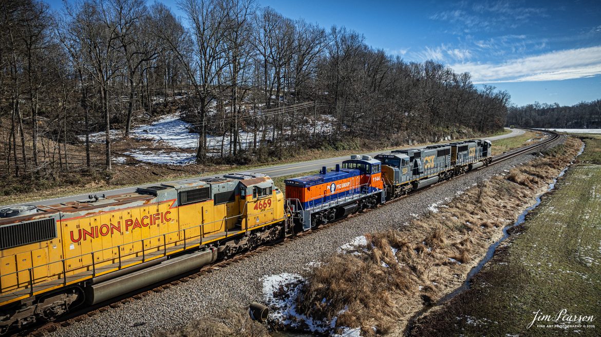 CSX M513 heads out of Sebree, Kentucky, on January 17th, 2025, as they make their way south on the CSX Henderson Subdivision.

M513 has PCS Group Switcher 1144 as the third unit and an ex-Union Pacific 4669 with reporting marks of SPTX stenciled on the side of the cab, with both units dead in tow.

According to their website, “PSC Group provides turnkey solutions for safe and efficient rail switching in some of the most challenging and complex sites throughout North America. We manage more than 75 rail switching sites using our own fleet of advanced locomotives and mobile railcar movers, proven safety methods, and highly skilled personnel. By working closely with our customers, we tailor our services to their unique needs, utilizing over 80 locomotives, 30 mobile railcar movers (Trackmobiles and Shuttle Wagons), and more than 1,000 skilled employees to enhance safety, decrease cycle time, prevent derailments, and optimize railcar utilization.

Over the years, we have found that performing railcar switching alongside loading/unloading, railcar repair, and inspections, creates a safer and more efficient operating environment while simultaneously delivering considerable savings. By bundling these synergistic services together, we can provide the most value to our customers' operations.”

However, I can’t find much information on the SPTX Reporting mark so if anyone can provide me with some, I’d appreciate it!

Tech Info: DJI Mavic 3 Classic Drone, RAW, 24mm, f/2.8, 1/2000, ISO 130.

#bestphoto #trains #bestsoldpicture #JimPearsonPhotography #trainsfromtheair #trainsfromadrone