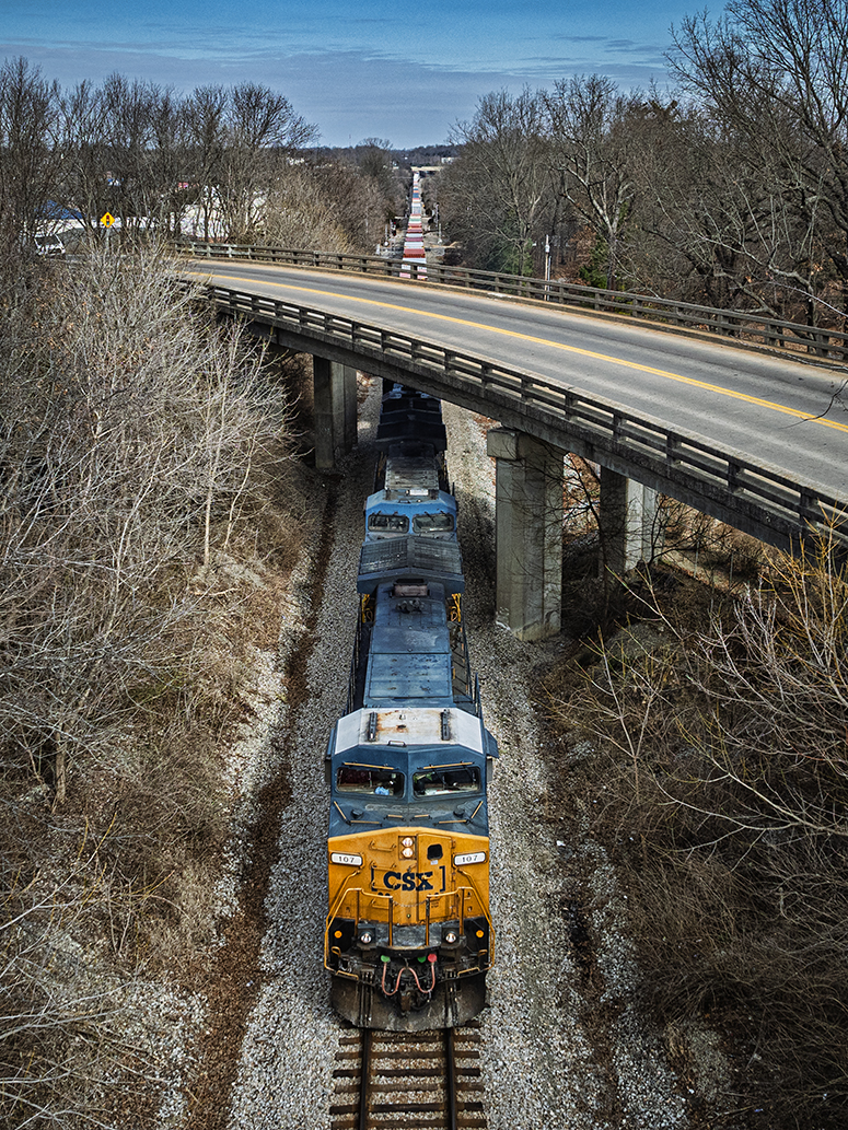 CSXT 107 leads a hot intermodal, I026, as it heads southbound under the North Main Street overpass at Madisonville, Kentucky, on the CSX Henderson Subdivision on January 23rd, 2024.

Tech Info: DJI Mavic 3 Classic Drone, RAW, 24mm, f/2.8, 1/2000, ISO 140.

#railroad #railroads #train, #trains #railway #railway #railtransport #railroadengines #picturesoftrains #picturesofrailways #besttrainphotograph #bestphoto #photographyoftrains #bestsoldpicture #JimPearsonPhotography #trainsfromadrone