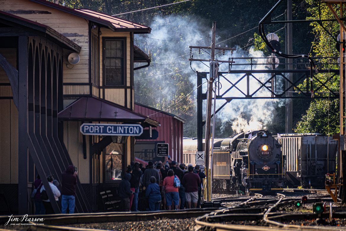 Passengers crowd the depot at Port Clinton, PA and take pictures as Reading Blue Mountain & Northern Railroad steam locomotive 2102 arrives at the station at Port Clinton, Pennsylvania on October 5th, 2024,during its first day of the year of pulling Fall Foliage Excursions.

According to their website: The Reading Company T-1 class #2102 was built in the Reading’s own locomotive shops in 1945. With drivers of 70” diameter, it weighs 404 tons, and its tender holds up to 26 tons of coal, and up to 19,000 gallons of water. After the Reading Steam era was over, the Reading Company used 2102 for the Reading Rambles on several different excursions. The 2102 has had many different owners since it was retired by the Reading Railroad. It is one of only four to survive. The other remaining locomotives are the 2100, 2101, and 2124.

The Blue Mountain and Reading Railroad purchased the 2102 in 1987, and it ran on the Temple to South Hamburg line into the early 1990’s. Once the Blue Mountain and Reading Railroad became the Reading Blue Mountain & Northern, the 2102 ran over Reading & Northern’s rails for a short time before it was removed from service in the early 1990’s. 

In 2022, steam locomotive 2102 reentered service on the Reading & Northern. The locomotive has been used actively to pull both passenger excursions and revenue freight trains.

Tech Info: Nikon D810, RAW, Nikon 70-300 @ 300mm, f/5.6, 1640, ISO 450.

#steamtrains #besttrainphotograph #JimPearsonPhotography #RBNRR