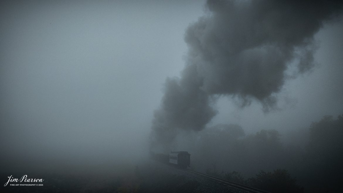 East Broad Top (EBT) steam locomotive #16 pulls a mixed freight through as they disappear into the early morning fog on their way to Rockhill Furnace, Pennsylvania on October 6th, 2024, during the museum’s Friends of the East Broad top event.

According to the East Broad Top Website: Locomotive #16 was built in 1916 by the Baldwin Locomotive Works.

Entering the age of modern steam in 1916, the EBT received its first of three large Mikados. Unlike the previous three smaller locomotives, #16 came with superheaters, piston valves, and Southern valve gear. One story mentions #16 pulled 60 empty hoppers from Mt. Union to Rockhill in one train, literally clearing out the yard. #16 underwent an overhaul in 1955 and made only a handful of trips in early 1956 before the railroad shut down an overhaul when the EBT shut down. On February 1, 2023, the locomotive returned to service.

Tech Info: DJI Mavic 3 Classic Drone, RAW, 24mm, f/2.8, 1/500, ISO 100.

#railroad #railroads #train, #trains #railway #railway #steamtrains #railtransport #railroadengines #picturesoftrains #picturesofrailways #besttrainphotograph #bestphoto #photographyoftrains #bestsoldpicture #JimPearsonPhotography #trainsfromtheair #trainsfromadrone #eastbroadtop