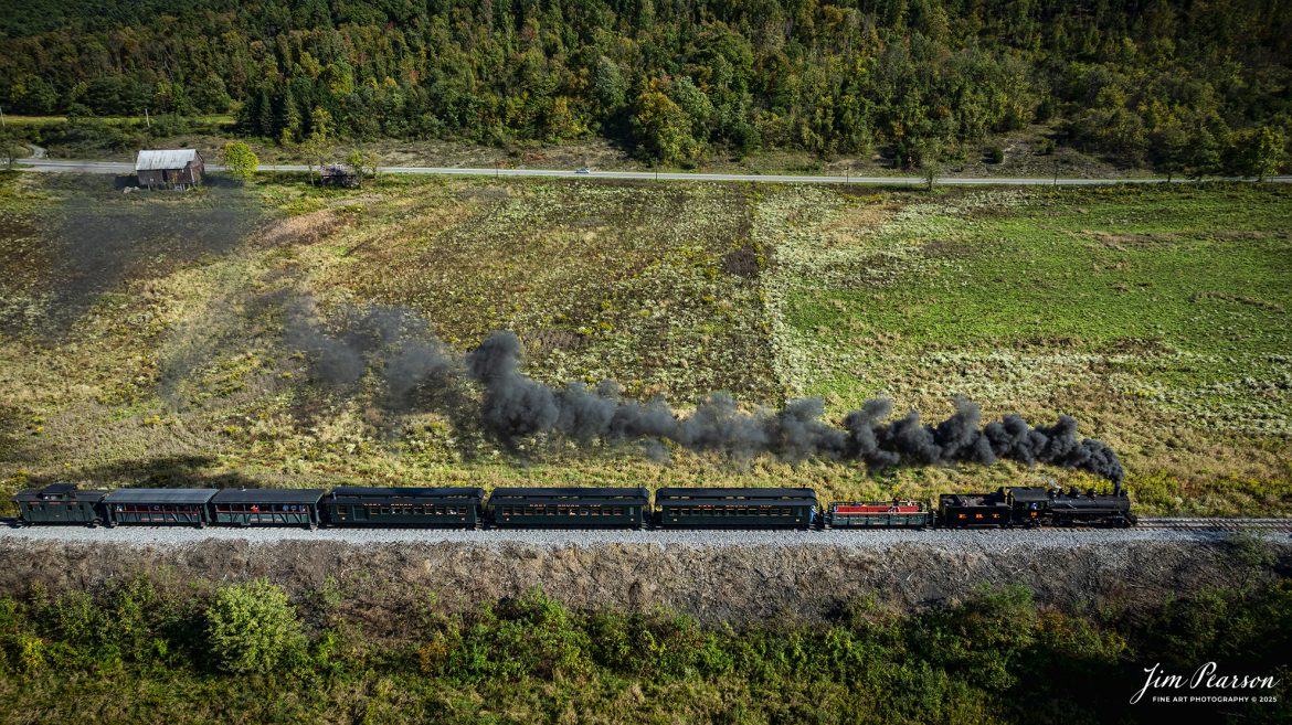 East Broad Top steam locomotive 16 pulls a mixed freight through the countryside on their way to Rockhill Furnace, Pennsylvania on October 6th, 2024, during the museum’s Friends of the East Broad top event.

According to the East Broad Top Website: Locomotive #16 was built in 1916 by the Baldwin Locomotive Works.

Entering the age of modern steam in 1916, the EBT received its first of three large Mikados. Unlike the previous three smaller locomotives, #16 came with superheaters, piston valves, and Southern valve gear. One story mentions #16 pulled 60 empty hoppers from Mt. Union to Rockhill in one train, literally clearing out the yard. #16 underwent an overhaul in 1955 and made only a handful of trips in early 1956 before the railroad shut down an overhaul when the EBT shut down. On February 1, 2023, the locomotive returned to service.

Tech Info: DJI Mavic 3 Classic Drone, RAW, 24mm, f/2.8, 1/500, ISO 100.

#railroad #railroads #train, #trains #railway #railway #steamtrains #railtransport #railroadengines #picturesoftrains #picturesofrailways #besttrainphotograph #bestphoto #photographyoftrains #bestsoldpicture #JimPearsonPhotography #trainsfromtheair #trainsfromadrone #eastbroadtop