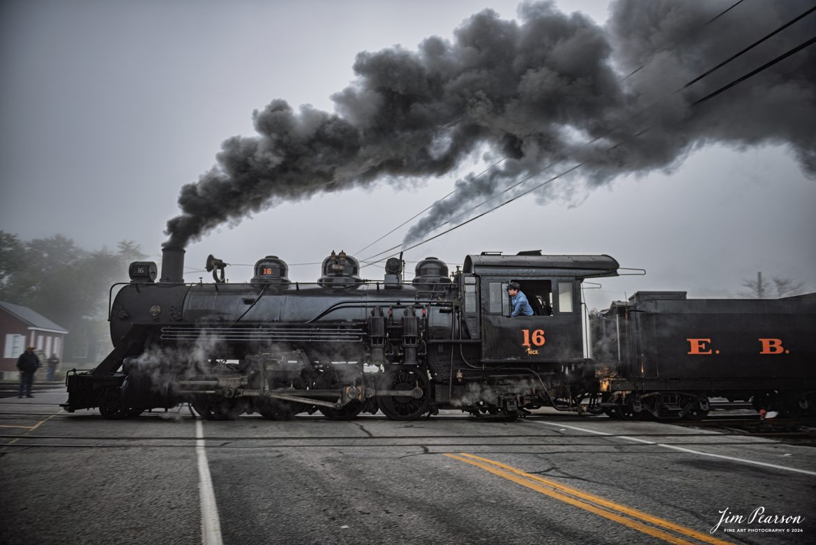 The fireman on East Broad Top steam locomotive 16 keeps a watchful eye ahead as they pull their train through the crossing next to the depot at Rockhill Furnace, Pennsylvania in preparation for another trip, on October 6th, 2024 in the early morning fog.

According to the East Broad Top Website: Locomotive #16 was built in 1916 by the Baldwin Locomotive Works.

Entering the age of modern steam in 1916, the EBT received its first of three large Mikados. Unlike the previous three smaller locomotives, 16 came with superheaters, piston valves, and Southern valve gear. One story mentions #16 pulled 60 empty hoppers from Mt. Union to Rockhill in one train, literally clearing out the yard. #16 underwent an overhaul in 1955 and made only a handful of trips in early 1956 before the railroad shut down an overhaul when the EBT shut down. On February 1, 2023, the locomotive returned to service.

Tech Info: Nikon D810, RAW, Nikon 24-70 @ 24mm, f/2.8, 1/50, ISO 90.

#steamtrains #JimPearsonPhotography #eastbroadtop