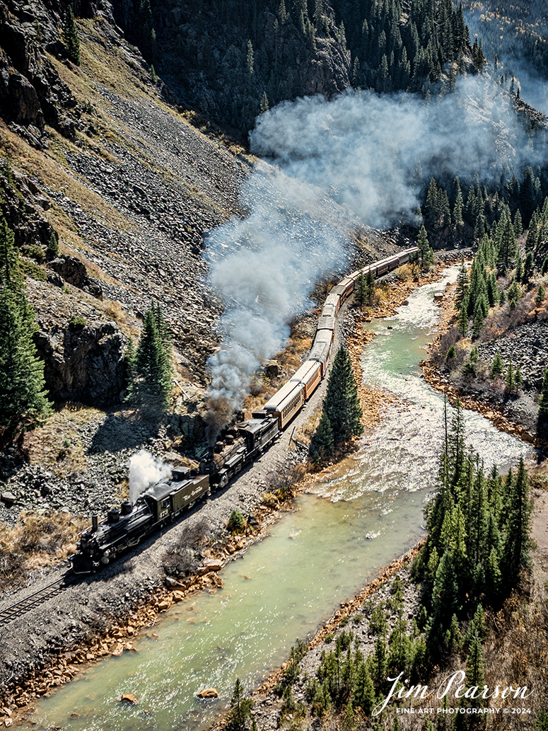 Denver and Rio Grande Western double header steam locomotives 473 and 493 pull one of several daily passenger trains south through Deadwood Gulch, as they approach Silverton, Colorado on October 15th, 2023.

According to Wikipedia: The Durango and Silverton Narrow Gauge Railroad, often abbreviated as the D&SNG, is a 3 ft (914 mm) narrow-gauge heritage railroad that operates on 45.2 mi (72.7 km) of track between Durango and Silverton, in the U.S. state of Colorado. The railway is a federally designated National Historic Landmark and was also designated by the American Society of Civil Engineers as a National Historic Civil Engineering Landmark in 1968.

Tech Info: DJI Mavic 3 Classic Drone, RAW, 22mm, f/2.8, 1/1250, ISO 180.

#railroad #railroads #train #trains #bestphoto #railroadengines #picturesoftrains #picturesofrailway #bestphotograph #photographyoftrains #trainphotography #JimPearsonPhotography #DurangoandSilvertonRailroad #trending