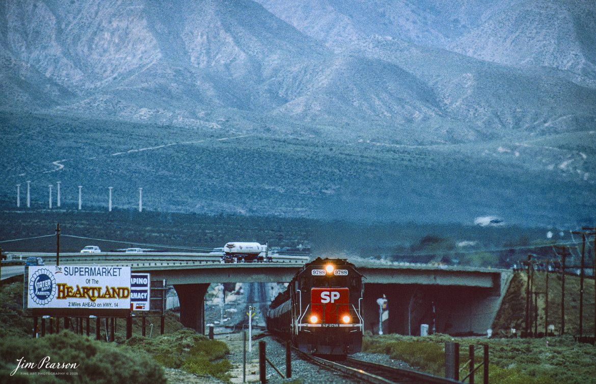 Film Wednesday – Southern Pacific 9788 leads a tank train as it heads through the Tehachapi mountains out of Mojave, California, in this film scan from a Kodachrome slide that was shot sometime in the early 1990’s. 

According to Wikipedia: The Southern Pacific (reporting mark SP) (or Espee from the railroad initials) was an American Class I railroad network that existed from 1865 to 1996 and operated largely in the Western United States. The system was operated by various companies under the names Southern Pacific Railroad, Southern Pacific Company and Southern Pacific Transportation Company.

The original Southern Pacific began in 1865 as a land holding company. The last incarnation of the Southern Pacific, the Southern Pacific Transportation Company, was founded in 1969 and assumed control of the Southern Pacific system. The Southern Pacific Transportation Company was acquired in 1996 by the Union Pacific Corporation and merged with their Union Pacific Railroad.

Tech Info: Camera, Nikon F3, Kodachrome Slide Film, no other data recorded

#slidescan #filmphotography #trains #railroads #jimpearsonphotography