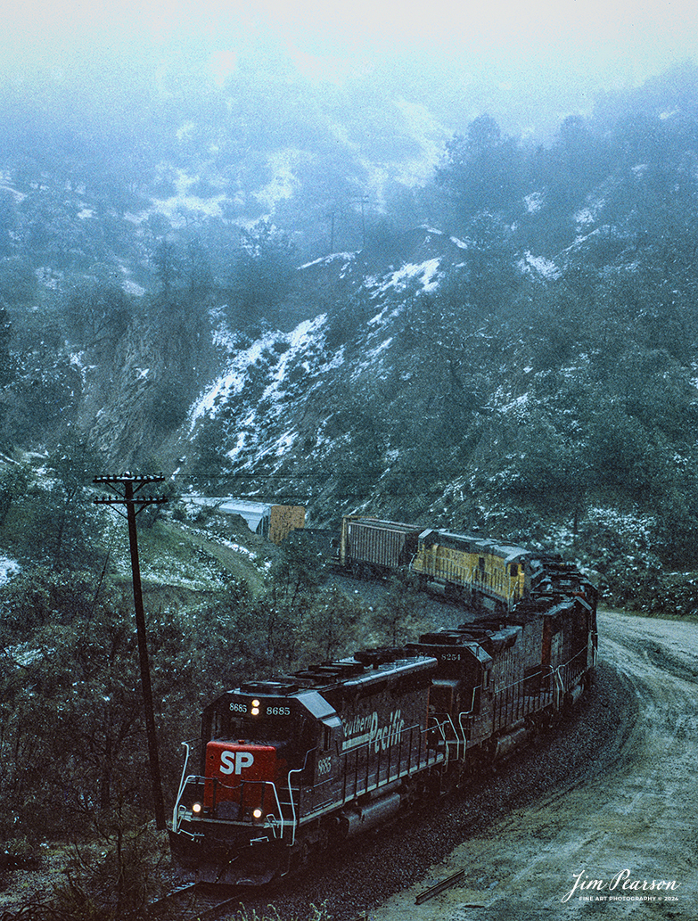 Film Wednesday – Southern Pacific 8685 leads a mixed freight as it heads through the Tehachapi mountains in California, in this film scan from a Kodachrome slide that was shot sometime in the early 1990’s. 

According to Wikipedia: The Southern Pacific (reporting mark SP) (or Espee from the railroad initials) was an American Class I railroad network that existed from 1865 to 1996 and operated largely in the Western United States. The system was operated by various companies under the names Southern Pacific Railroad, Southern Pacific Company and Southern Pacific Transportation Company.

The original Southern Pacific began in 1865 as a land holding company. The last incarnation of the Southern Pacific, the Southern Pacific Transportation Company, was founded in 1969 and assumed control of the Southern Pacific system. The Southern Pacific Transportation Company was acquired in 1996 by the Union Pacific Corporation and merged with their Union Pacific Railroad.

Tech Info: Camera, Nikon F3, Kodachrome Slide Film, no other data recorded

#slidescan #filmphotography #trains #railroads #jimpearsonphotography