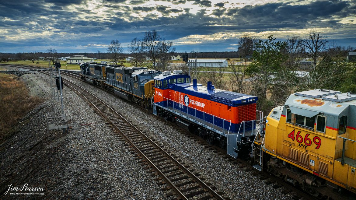 CSX M513 passes through the north end of Kelly, Kentucky, on January 17th, 2025, as they head south on the Henderson Subdivision.

M513 has PCS Group Switcher 1144 as the third unit and an ex-Union Pacific 4669 with reporting marks of SPTX stenciled on the side of the cab, with both units dead in tow.

According to their website, “PSC Group provides turnkey solutions for safe and efficient rail switching in some of the most challenging and complex sites throughout North America. We manage more than 75 rail switching sites using our own fleet of advanced locomotives and mobile railcar movers, proven safety methods, and highly skilled personnel. By working closely with our customers, we tailor our services to their unique needs, utilizing over 80 locomotives, 30 mobile railcar movers (Trackmobiles and Shuttle Wagons), and more than 1,000 skilled employees to enhance safety, decrease cycle time, prevent derailments, and optimize railcar utilization.

Over the years, we have found that performing railcar switching alongside loading/unloading, railcar repair, and inspections, creates a safer and more efficient operating environment while simultaneously delivering considerable savings. By bundling these synergistic services together, we can provide the most value to our customers' operations.”

However, I can’t find much information on the SPTX Reporting mark so if anyone can provide me with some, I’d appreciate it!

Tech Info: DJI Mavic 3 Classic Drone, RAW, 24mm, f/2.8, 1/1250, ISO 420.

#bestphoto #trains #bestsoldpicture #JimPearsonPhotography #trainsfromtheair #trainsfromadrone