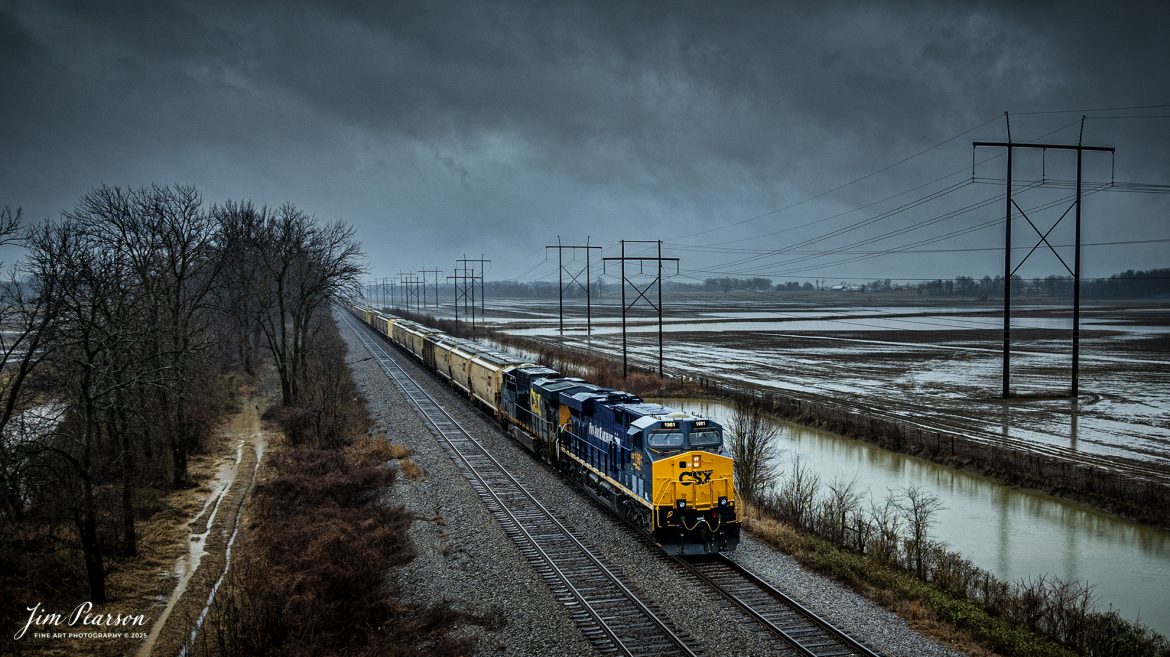 CSXT 1981 PanAm Railway Heritage Unit leads G342, under stormy skies, as it waits in the siding at the north end of Rankin, Kentucky for CSX I025 to pass, on February 15th, 2025, on the CSX Henderson Subdivision.

According to a CSXT Press Release: November 25, 2024 - CSX has unveiled locomotive No. 1981, the final installment in its series of heritage locomotives, honoring Pan Am Railways. The unit is the 21st and final creation by the Waycross Paint Shop to celebrate the predecessor railroads that form today’s CSX network.

Pan Am Railways, formerly known as Guilford Transportation, was established in 1981 and operated across northern New England, spanning from Maine to New York. It joined the CSX family in 2022 following a purchase agreement.

The heritage series required extra care and precision, according to CSX carman painter Albert Bussey. “It's always special working on the heritage units,” Bussey said. “Like always, we try to take a little bit of extra care and time in order to do these perfectly.”

All 21 heritage units are not just displays of craftsmanship but active locomotives performing daily duties throughout CSX’s 26-state rail network. The dedication behind their creation reflects the artistry of the team at the Waycross Paint Shop.

“I've been involved in all of the 21 units,” said CSX carman painter Clyde Marshall. “The work itself has really been enjoyable. The transformation of the units, from when they first arrive in the shop to the finished product, is very rewarding.

Marshall also noted the significance of connecting with railroad history through these projects. “It is an honor to learn about the history of these units, and the importance the railroad played in American history,” he added.

The completion of locomotive No. 1981 stands as a tribute to the history of Pan Am Railways and the pride shared by CSX employees. As CSX approaches its 200th anniversary in 2027, these heritage locomotives symbolize the company’s enduring legacy and its dedication to innovation and service.

Tech Info: DJI Mavic 3 Classic Drone, RAW, 24mm, f/2.8, 1/320, ISO 130

#railroad #railroads #train, #trains #railway #railway #railtransport #railroadengines #picturesoftrains #picturesofrailways #besttrainphotograph #bestphoto #onecsx #photographyoftrains #bestsoldpicture #JimPearsonPhotography #trainsfromadrone #csxheritageunit