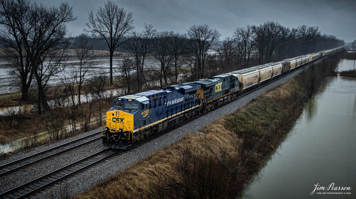 CSXT 1981 PanAm Railway Heritage Unit leads G342, under stormy skies, as it waits in the siding at the north end of Rankin, Kentucky for CSX I025 to pass, on February 15th, 2025, on the CSX Henderson Subdivision.

According to a CSXT Press Release: November 25, 2024 - CSX has unveiled locomotive No. 1981, the final installment in its series of heritage locomotives, honoring Pan Am Railways. The unit is the 21st and final creation by the Waycross Paint Shop to celebrate the predecessor railroads that form today’s CSX network.

Pan Am Railways, formerly known as Guilford Transportation, was established in 1981 and operated across northern New England, spanning from Maine to New York. It joined the CSX family in 2022 following a purchase agreement.

The heritage series required extra care and precision, according to CSX carman painter Albert Bussey. “It's always special working on the heritage units,” Bussey said. “Like always, we try to take a little bit of extra care and time in order to do these perfectly.”

All 21 heritage units are not just displays of craftsmanship but active locomotives performing daily duties throughout CSX’s 26-state rail network. The dedication behind their creation reflects the artistry of the team at the Waycross Paint Shop.

“I've been involved in all of the 21 units,” said CSX carman painter Clyde Marshall. “The work itself has really been enjoyable. The transformation of the units, from when they first arrive in the shop to the finished product, is very rewarding.

Marshall also noted the significance of connecting with railroad history through these projects. “It is an honor to learn about the history of these units, and the importance the railroad played in American history,” he added.

The completion of locomotive No. 1981 stands as a tribute to the history of Pan Am Railways and the pride shared by CSX employees. As CSX approaches its 200th anniversary in 2027, these heritage locomotives symbolize the company’s enduring legacy and its dedication to innovation and service.

Tech Info: DJI Mavic 3 Classic Drone, RAW, 24mm, f/2.8, 1/240, ISO 140

#railroad #railroads #train, #trains #railway #railway #railtransport #railroadengines #picturesoftrains #picturesofrailways #besttrainphotograph #bestphoto #onecsx #photographyoftrains #bestsoldpicture #JimPearsonPhotography #trainsfromadrone #csxheritageunit