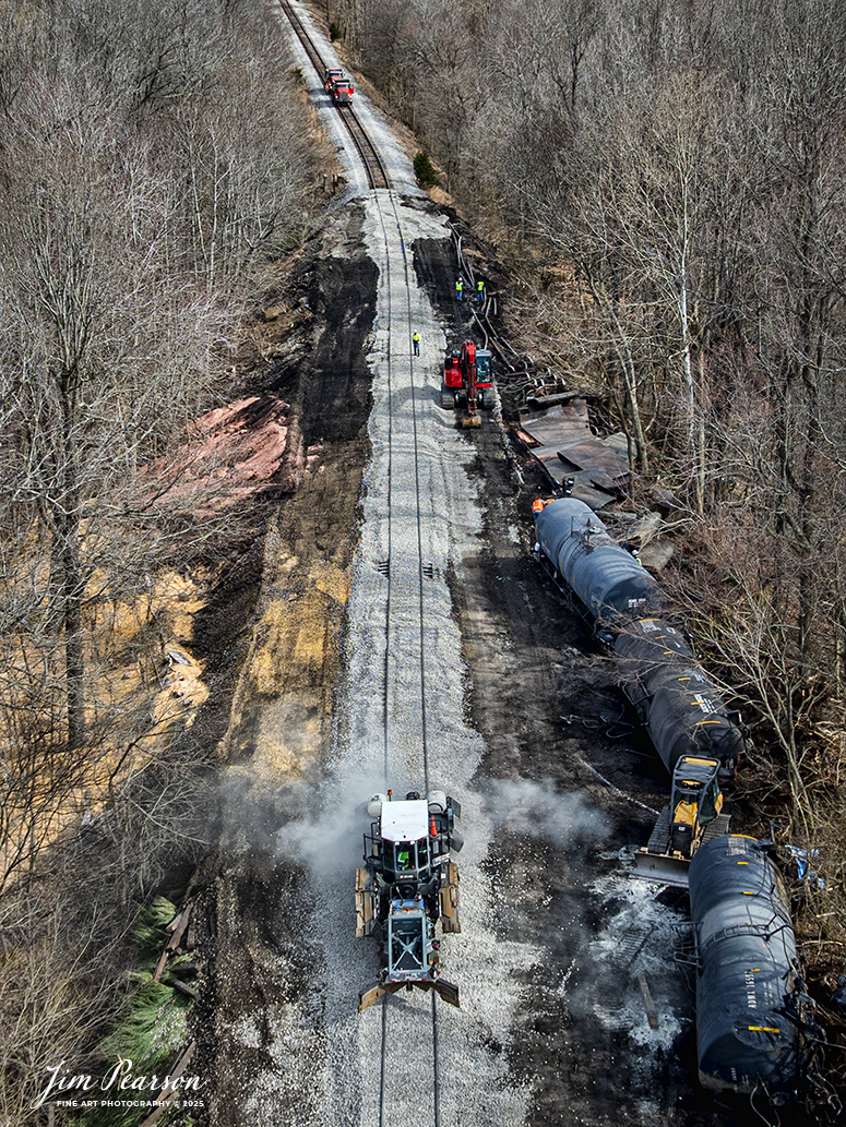 A CSX ballaster works on the recently repaired track from the M501 derailment site on the cutoff track for the CSX Henderson Subdivision, just outside of Mortons Gap, Ky, on March 3rd, 2025. The derailment happened in the early morning hours on March 2nd, 2025, as the train was approaching Mortons Junction, after R&B Enterprises out of Mississippi worked on removing the cars and repairing the tracks. 

I’m told that a broken drawbar was likely what caused the derailment, but that’s not official. No one was injured in this event. The track is currently back open with a speed restriction.

Tech Info: DJI Mavic 3 Classic Drone, RAW, 22mm, f/2.8, 1/1600, ISO 120.

#railroad #railroads #train, #trains #railway #railway #railtransport #railroadengines #picturesoftrains #picturesofrailways #besttrainphotograph #bestphoto #photographyoftrains #bestsoldpicture #JimPearsonPhotography #trainsfromadrone #trainderailment #csxhendersonsubdivision #onecsx