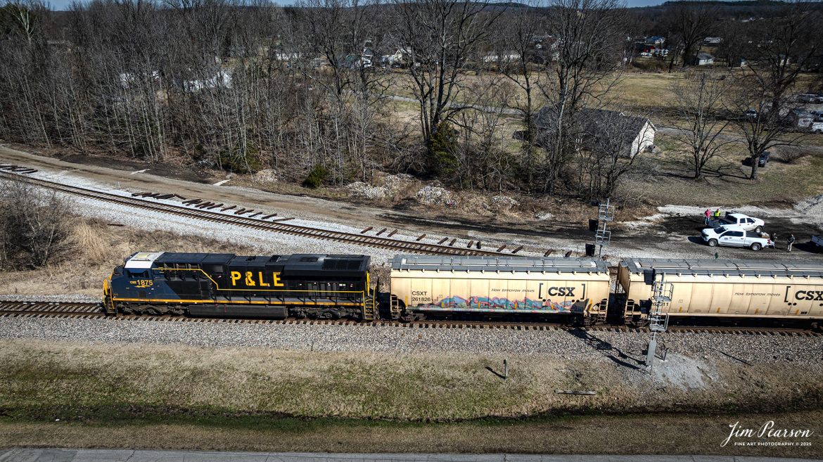 CSXT 1875 P&LE Heritage unit leads CSX G412 northbound at Mortons Junction in Mortons Gap, Ky, on March 3rd, 2025, on the CSX Henderson Subdivision.

According to a CSX Press Release: June 6, 2024 – CSX has released a new heritage locomotive, the P&LE 1875, paying tribute to the storied Pittsburgh & Lake Erie Railroad (P&LE). The 15th in CSX’s heritage locomotive series, this new addition to the company’s fleet not only celebrates the rich history of P&LE but also marks a significant milestone in CSX’s ongoing commitment to honoring the legacies of America’s historic railroads.

The Pittsburgh & Lake Erie Railroad was established in 1875 with a primary mission of transporting essential industrial materials such as coal, coke, iron ore, limestone, and steel among the bustling industrial hubs of the region.

“It’s mainline connected Pittsburgh, Pennsylvania with Youngstown, Ohio and Connellsville, Pennsylvania. It did not actually reach Lake Erie until 1976,” explained Tim Music, a carman painter at the CSX Waycross Locomotive Shop where the unit was produced.

Despite its relatively modest route mileage, the P&LE Railroad earned the nickname “Little Giant” due to the enormous volume of heavy tonnage it moved. This impressive capability drew significant attention and by 1887, the P&LE became a subsidiary of the dominant New York Central Railroad. Under this new ownership, the P&LE enjoyed substantial improvements to its tracks and added capacity for passenger services, further enhancing its regional significance.

Over time, P&LE expanded by leasing branches from smaller railroads. These extensions included lines southeast along the Monongahela River through Homestead and McKeesport, and along the Youghiogheny River to Connellsville, where it connected with the Western Maryland Railway.

Tech Info: DJI Mavic 3 Classic Drone, RAW, 22mm, f/2.8, 1/2000, ISO 110.

#railroad #railroads #train, #trains #railway #railway #railtransport #railroadengines #picturesoftrains #picturesofrailways #besttrainphotograph #bestphoto #photographyoftrains #bestsoldpicture #JimPearsonPhotography #trainsfromadrone #trainderailment #csxhendersonsubdivision #onecsx