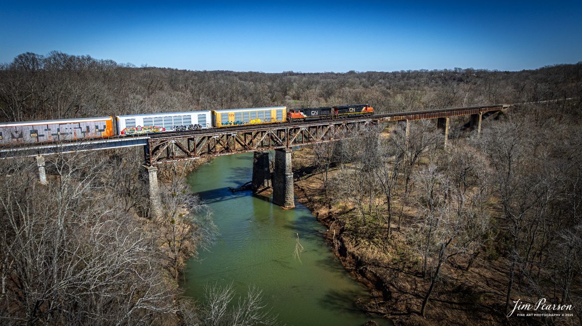 Canadian National 2257 leads CSX X217 empty autorack train southbound across the Red River at Adams, Tennessee on March 11th, 2025, on the CSX Henderson Subdivision. The train is running as an extra M217 as it makes its way from Philadelphia, PA to Louisville, Ky.

Tech Info: DJI Mavic 3 Classic Drone, RAW, 22mm, f/2.8, 1/2000, ISO 100.

#railroad #railroads #train, #trains #railway #railway #railtransport #railroadengines #picturesoftrains #picturesofrailways #besttrainphotograph #bestphoto #photographyoftrains #bestsoldpicture #JimPearsonPhotography #trainsfromadrone #csxhendersonsubdivision #onecsx