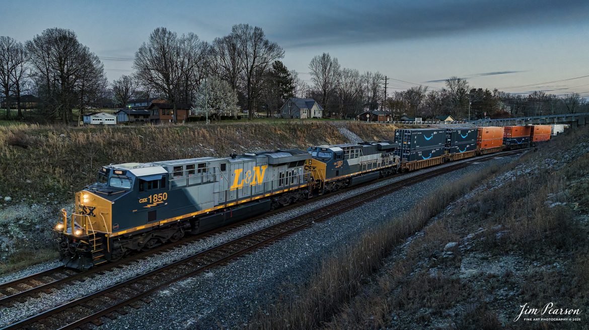 CSX Heritage Units, L&N 1850 and NYC 1853 lead CSX I026-22 as they head into the S curve at Nortonville, Kentucky as they make their way north at dusk, on the Henderson Subdivision on March 22nd, 2025.

According to CSXT: CSX has introduced the sixth and eighth locomotives in its heritage series, a freshly painted unit honoring the Louisville & Nashville Railroad. Designated CSX 1850, the locomotive will be placed into service, carrying the L&N colors across the 20,000-mile CSX network. 

Designated CSX 1853 is in recognition of the year the NYC was founded; this heritage unit was repainted in a special design combining the current CSX colors with the traditional gray and white of the NYC system.

The paint schemes were designed and applied at the CSX Locomotive Shop in Waycross, Georgia, which has produced all units in the heritage series celebrating the lines that came together to form the modern CSX. Like the other heritage locomotives, these units combine the heritage railroads iconic logo and colors on the rear two-thirds of the engine with today’s CSX colors and markings on the cab end.

Tech Info: DJI Mavic 3 Classic Drone, RAW, 22mm, f/2.8, 1/500, ISO 800.

#railroad #railroads #train, #trains #railway #railway #railtransport #railroadengines #picturesoftrains #picturesofrailways #besttrainphotograph #bestphoto #photographyoftrains #bestsoldpicture #JimPearsonPhotography #trainsfromadrone #csxhendersonsubdivision #onecsx #csxheritageunits