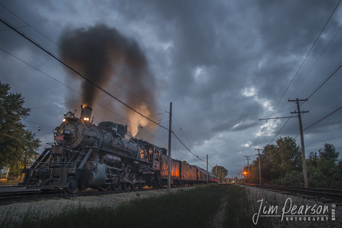 September 1, 2018 - St. Louis-San Francisco Railroad steam locomotive 1630 sits in the station at the Illinois Railway Museum in Union, Illinois, waiting for it's 8pm run, as the last light of day begins to fade from the sky. 

According to Wikipedia, the locomotive was built in 1918 by the Baldwin Locomotive Works for use in Russia as a class Ye locomotive. However, it, along with approximately 200 other locomotives, remained in the United States, due to the inability of the Bolshevik government to pay for them, following the Russian Revolution. 

1630 was converted from 5 ft (1,524 mm) Russian track gauge to 4 ft 8 1/2 in (1,435 mm) standard gauge. After being re-gauged, #1630 was sold to the USRA and was numbered 1147. Shortly after, 1147 was briefly leased for use on the Pennsylvania Railroad. 

In 1920, the locomotive was sold to the St. Louis  San Francisco Railway, where it was used as a mixed traffic engine. In 1951, the locomotive was sold to Eagle-Picher, who used it to haul lead ore from a mine to their smelter. 

In 1967, the locomotive was donated to the Illinois Railway Museum, in Union, Illinois, where they began restoring it in 1972, it returned to operating condition in 1974 and made its first revenue run. Sometime after arriving at the museum, 1630 was restored from her Eagle Picher appearance back to her Frisco appearance. 1630 was taken out of service in 2004, and after more than six years undergoing repairs and a federally mandated rebuild, it was returned to operational condition on October 30, 2013.

On Memorial Day weekend 2014, the locomotive returned to excursion service. In 2016, the locomotive received a cylinder overhaul, which according to Steam department curator, Nigel Bennett, made the locomotive, "probably more powerful than she has been since her [sic] first arrival at IRM in the 1970s." The locomotive, during Memorial Day weekend 2016, pulled 137 empty coal cars in storage at the museum as what was considered to be one of the longest revenue freight trains powered by a steam locomotive in at least 25 years as said by IRM's Steam department curator. 

- #jimstrainphotos #illinoisrailroads #steamtrains #nikond800 #railroad #railroads #train #railways #railway #illinoisrailwaymuseum #steamtrain